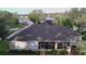 Aerial view of the home highlighting the roof, screened lanai, and surrounding community at 10812 Versailles Blvd. Blvd, Clermont, FL 34711
