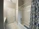 Neutral toned bathroom featuring a shower-tub combo with white tiled walls and floors at 10812 Versailles Blvd. Blvd, Clermont, FL 34711