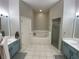 Bright primary bathroom with double sinks, a soaking tub, and a separate shower at 10812 Versailles Blvd. Blvd, Clermont, FL 34711