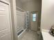Bright bathroom with a shower-tub combo and a door leading to the outside of the home at 10812 Versailles Blvd. Blvd, Clermont, FL 34711