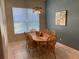 Cozy dining room with wood table, six chairs, a decorative centerpiece, and stylish light fixture at 10812 Versailles Blvd. Blvd, Clermont, FL 34711