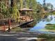 Exterior view of the private boat dock with a covered gazebo overlooking the water at 10812 Versailles Blvd. Blvd, Clermont, FL 34711