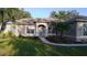 Well-maintained home with a landscaped front yard, inviting entryway, and lots of natural light at 10812 Versailles Blvd. Blvd, Clermont, FL 34711