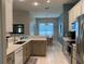 Bright kitchen featuring stainless steel appliances, white cabinets, and a dining area at 10812 Versailles Blvd. Blvd, Clermont, FL 34711