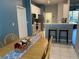 Open kitchen view showing breakfast bar with seating and stainless steel appliances at 10812 Versailles Blvd. Blvd, Clermont, FL 34711