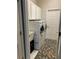 Convenient laundry room with modern washer and dryer, storage cabinets, and stylish rug at 10812 Versailles Blvd. Blvd, Clermont, FL 34711