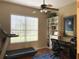 Bright and functional office space with a ceiling fan, a large window and a treadmill at 10812 Versailles Blvd. Blvd, Clermont, FL 34711