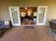 Outdoor patio with brick flooring and comfortable seating, opening up to an inviting interior at 10812 Versailles Blvd. Blvd, Clermont, FL 34711