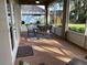 Outdoor patio featuring brick flooring and a glass table surrounded by seating and greenery at 10812 Versailles Blvd. Blvd, Clermont, FL 34711