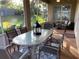 Outdoor brick patio with glass topped table, outdoor couch, string lights, and outdoor greenery at 10812 Versailles Blvd. Blvd, Clermont, FL 34711
