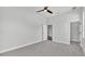 Bedroom with gray carpet, a ceiling fan, and an attached closet at 1180 Windjammer Dr, Lakeland, FL 33803