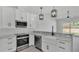 Open-concept kitchen featuring granite countertops, a stainless steel dishwasher, and modern pendant lighting at 1180 Windjammer Dr, Lakeland, FL 33803