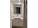 Chic bathroom boasts a unique geometric mirror, vessel sink, and stylish vanity for a modern touch at 11953 Delfina Ln, Orlando, FL 32827
