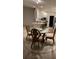 Cozy dining area with a glass-top table, four chairs, and nearby kitchen space, ideal for casual meals at 11953 Delfina Ln, Orlando, FL 32827