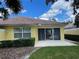 Rear exterior of home with terra cotta tile roof and sliding glass doors to patio at 11953 Delfina Ln, Orlando, FL 32827