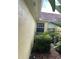 Image of the exterior, showing lush landscaping and a well-maintained yellow stucco wall at 11953 Delfina Ln, Orlando, FL 32827