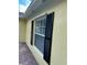 Exterior view of home with decorative shutters and brick walkway at 11953 Delfina Ln, Orlando, FL 32827