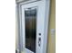 Close-up view of front door with decorative window and hardware at 11953 Delfina Ln, Orlando, FL 32827