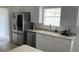 Bright kitchen with stainless steel appliances, white cabinetry, and a window providing natural light at 11953 Delfina Ln, Orlando, FL 32827