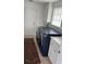 Functional laundry room with a blue washer and dryer, cabinetry, and easy access to an exterior door at 11953 Delfina Ln, Orlando, FL 32827