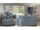 Bright living room with comfortable seating and sliding glass doors to patio at 11953 Delfina Ln, Orlando, FL 32827