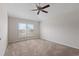 A well-lit room showcasing a ceiling fan, neutral walls, and plush carpeting for a cozy atmosphere at 120 Flatfish Ct, Kissimmee, FL 34759