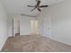 Spacious bedroom with neutral walls, a ceiling fan, carpet, and walk-in closet for ample storage at 120 Flatfish Ct, Kissimmee, FL 34759