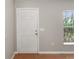 A simple entryway featuring a white six-panel door and a window providing natural light at 120 Flatfish Ct, Kissimmee, FL 34759