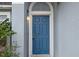 Inviting front door with decorative molding and a charming light fixture, creating a warm entrance at 120 Flatfish Ct, Kissimmee, FL 34759