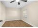 Cozy bedroom with ceiling fan, wood-look floors and a window for natural light at 126 Mason St, Auburndale, FL 33823