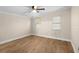 Bright bedroom with laminate flooring, two windows, and neutral-colored walls at 126 Mason St, Auburndale, FL 33823