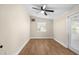 This bedroom features a ceiling fan, wood-look floors, and a window to the outside at 126 Mason St, Auburndale, FL 33823