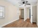 This bedroom features a ceiling fan, wood-look floors, and a closet at 126 Mason St, Auburndale, FL 33823