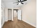 This bedroom features a ceiling fan, wood-look floors, and access to the outside at 126 Mason St, Auburndale, FL 33823