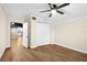 Bedroom featuring wood laminate flooring, ceiling fan, closet, and bright natural light at 126 Mason St, Auburndale, FL 33823