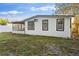 Exterior view of the home with a fenced yard and screened in porch at 126 Mason St, Auburndale, FL 33823