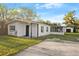 Charming single-story home featuring a white exterior, covered porch, and well-maintained landscaping at 126 Mason St, Auburndale, FL 33823