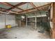 The interior of the garage has a concrete floor, exposed ceiling, and a mower inside at 126 Mason St, Auburndale, FL 33823