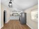 Open kitchen design featuring stainless steel appliances, white cabinets and wood-look flooring at 126 Mason St, Auburndale, FL 33823