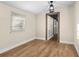 A neutral-colored living room boasting wood-look flooring and a decorative beam entryway at 126 Mason St, Auburndale, FL 33823