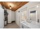 Mudroom featuring sink, wood-plank ceiling, and shelving with a bright window view at 126 Mason St, Auburndale, FL 33823