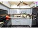 Kitchen with grey cabinetry, a black range, and a double sink, offering a functional cooking space at 1306 N Webster Ave, Lakeland, FL 33805