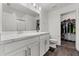 Well-lit bathroom featuring dual sinks, white cabinetry, and ample storage at 1341 Mattie Pointe Blvd, Auburndale, FL 33823
