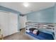 Bedroom with a bunk bed, light blue walls, and double doors at 1341 Mattie Pointe Blvd, Auburndale, FL 33823