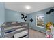 Bedroom with a bunk bed, light blue walls, and view of outside at 1341 Mattie Pointe Blvd, Auburndale, FL 33823