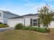 Well-maintained home featuring a tidy front lawn, pretty landscaping, and an attached two-car garage at 1341 Mattie Pointe Blvd, Auburndale, FL 33823