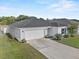 Charming single-story home with a two-car garage, well-manicured lawn, and lovely landscaping at 1341 Mattie Pointe Blvd, Auburndale, FL 33823