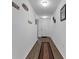 Bright hallway with wood-look floors and decor leading to other rooms of the house at 1341 Mattie Pointe Blvd, Auburndale, FL 33823