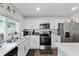 Charming kitchen showcasing stainless steel appliances and white cabinets at 1341 Mattie Pointe Blvd, Auburndale, FL 33823