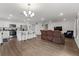 Open concept living space seamlessly integrates the kitchen with an island and the cozy living room at 1341 Mattie Pointe Blvd, Auburndale, FL 33823